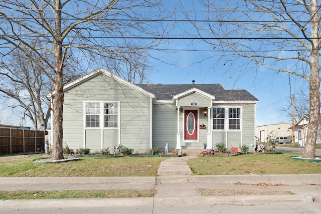 bungalow-style home with a front yard