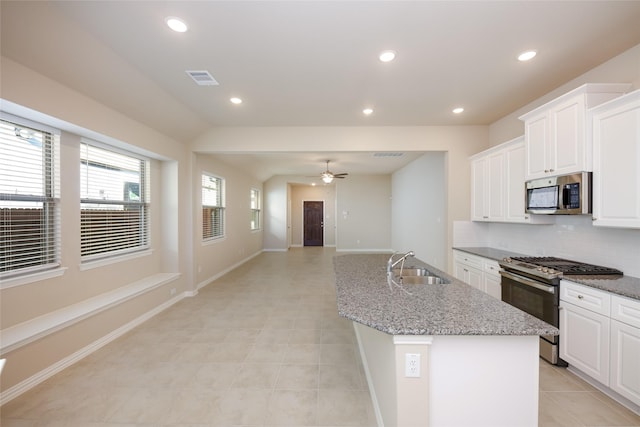 kitchen featuring a center island with sink, sink, ceiling fan, white cabinetry, and stainless steel appliances