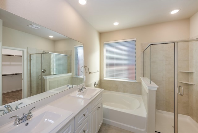 bathroom featuring tile patterned floors, vanity, and independent shower and bath