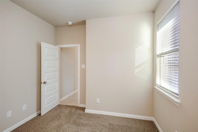 unfurnished room featuring light colored carpet