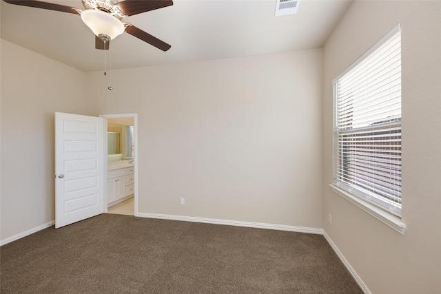 carpeted spare room with ceiling fan