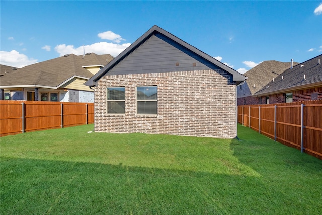 rear view of property featuring a yard