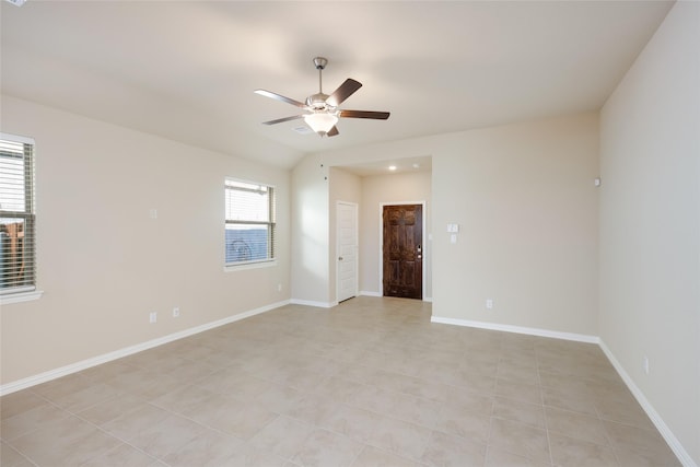 tiled spare room featuring ceiling fan and lofted ceiling