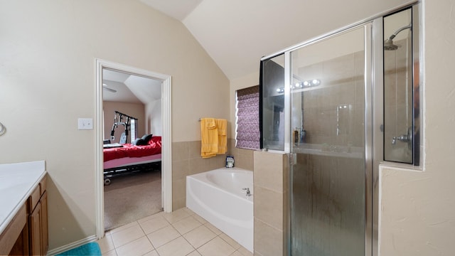 bathroom featuring shower with separate bathtub, vanity, tile patterned floors, and lofted ceiling