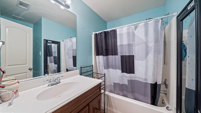 bathroom featuring vanity and shower / bath combo with shower curtain