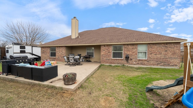 back of property with an outdoor living space, a yard, and a patio area