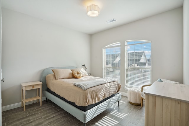 bedroom with dark wood-type flooring