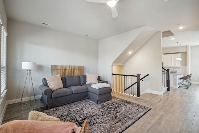 living room with ceiling fan and sink