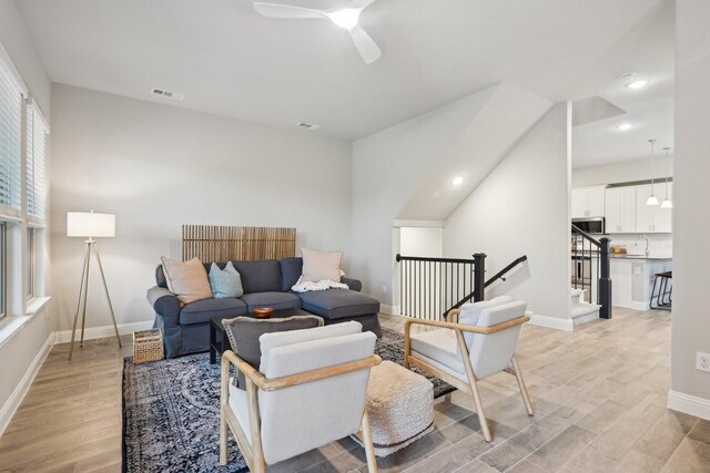 kitchen featuring decorative light fixtures, white cabinetry, stainless steel appliances, and kitchen peninsula