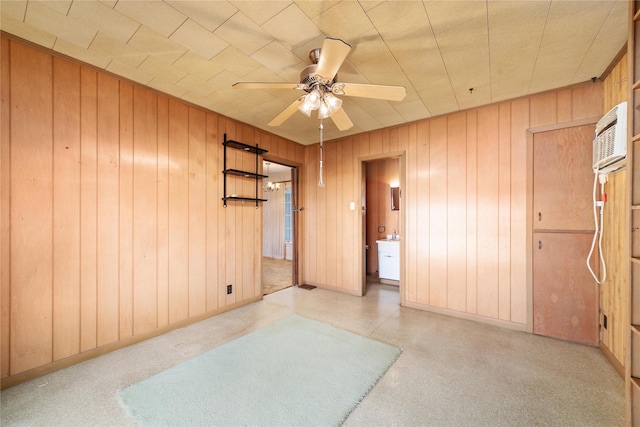 unfurnished room with ceiling fan and wooden walls