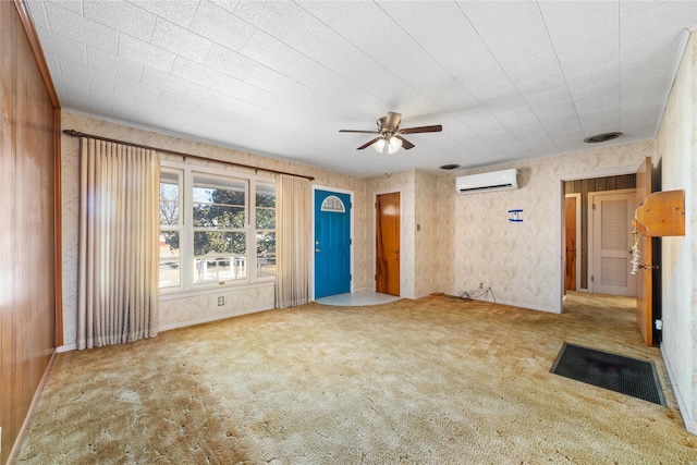 unfurnished living room with carpet flooring, a wall mounted AC, and ceiling fan