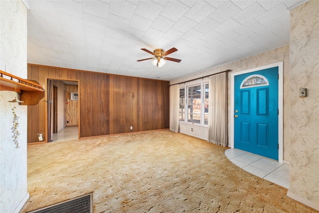 unfurnished living room with light carpet and ceiling fan