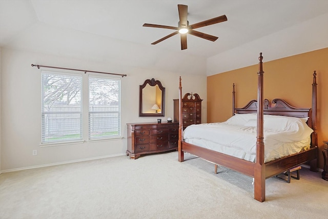 carpeted bedroom with baseboards, a ceiling fan, and vaulted ceiling