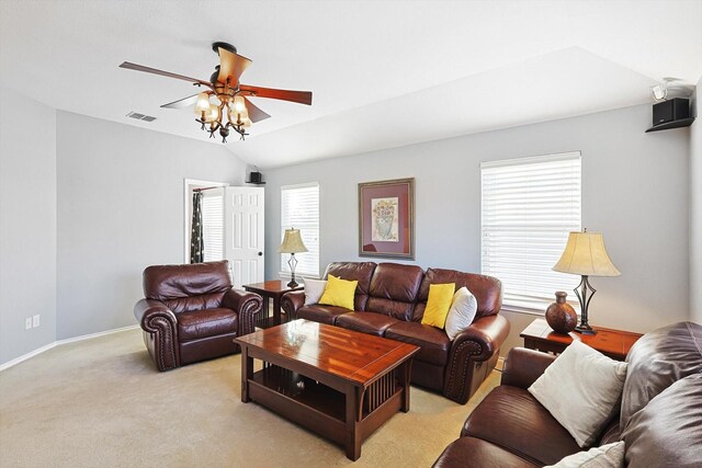 living area featuring visible vents, baseboards, lofted ceiling, light colored carpet, and ceiling fan