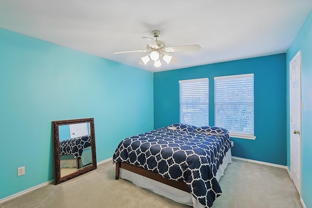 carpeted bedroom with baseboards and ceiling fan