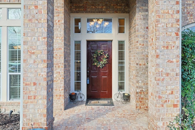 doorway to property with brick siding