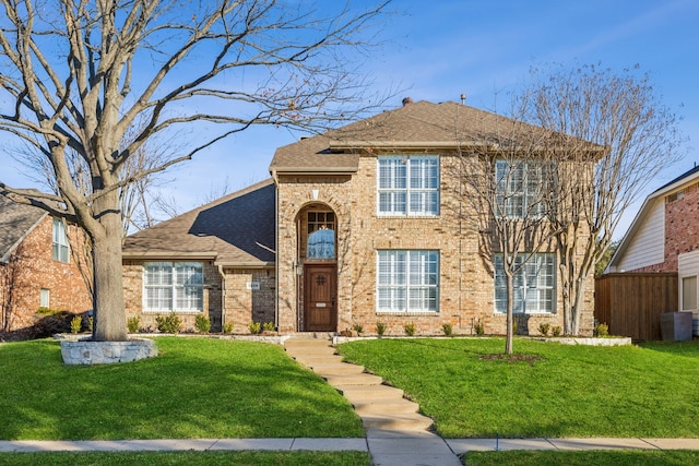 view of front of home featuring a front lawn and central air condition unit