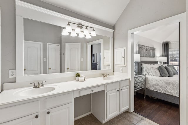 bathroom featuring vanity, lofted ceiling, and tile patterned flooring