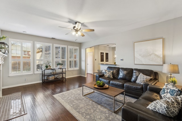 living room featuring ceiling fan and dark hardwood / wood-style floors