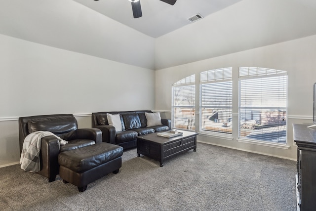 carpeted living room with ceiling fan and lofted ceiling