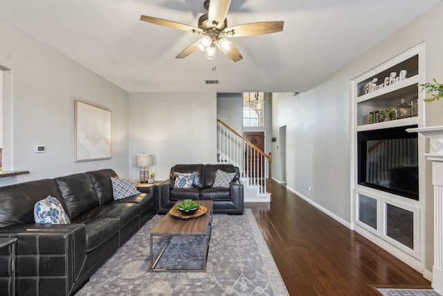 living room with ceiling fan and dark hardwood / wood-style floors