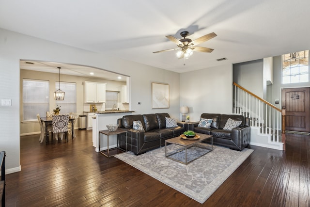 living room with ceiling fan and dark hardwood / wood-style floors