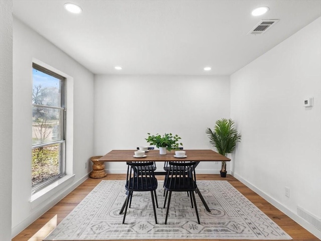 dining room featuring light hardwood / wood-style flooring and plenty of natural light