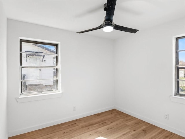 spare room with hardwood / wood-style floors and ceiling fan