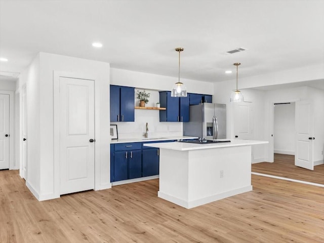 kitchen featuring blue cabinets, stainless steel refrigerator with ice dispenser, a center island, and light hardwood / wood-style floors