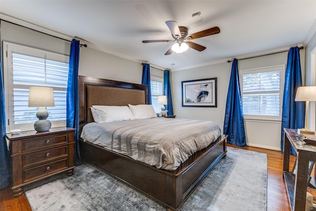 bedroom featuring hardwood / wood-style flooring, ceiling fan, and ornamental molding