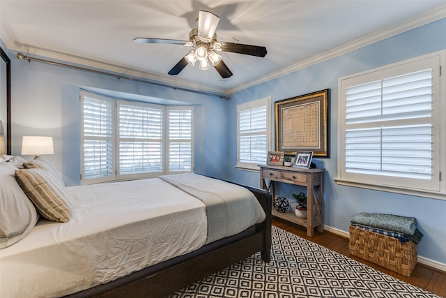 bedroom featuring ceiling fan, dark hardwood / wood-style floors, and crown molding