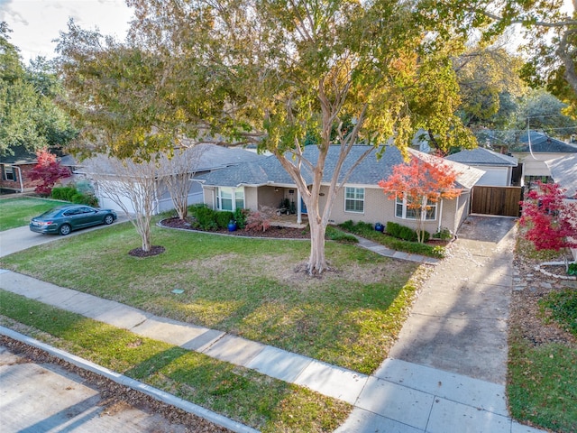 ranch-style home featuring a garage and a front lawn