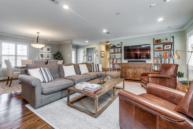 living room with hardwood / wood-style flooring and crown molding