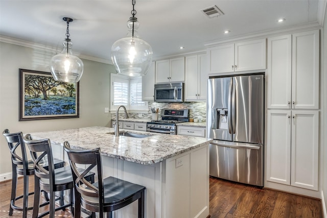 kitchen with a center island with sink, sink, white cabinetry, and stainless steel appliances