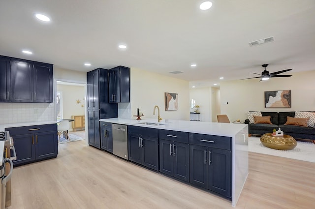 kitchen featuring dishwasher, light hardwood / wood-style floors, decorative backsplash, and sink