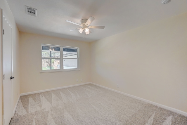 spare room featuring ceiling fan and light colored carpet