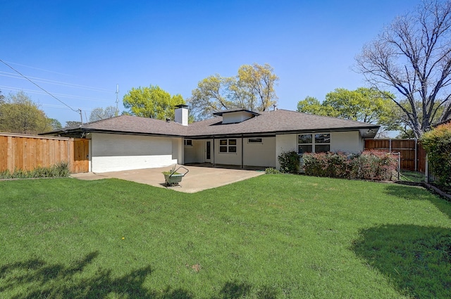 back of house featuring a yard and a patio area