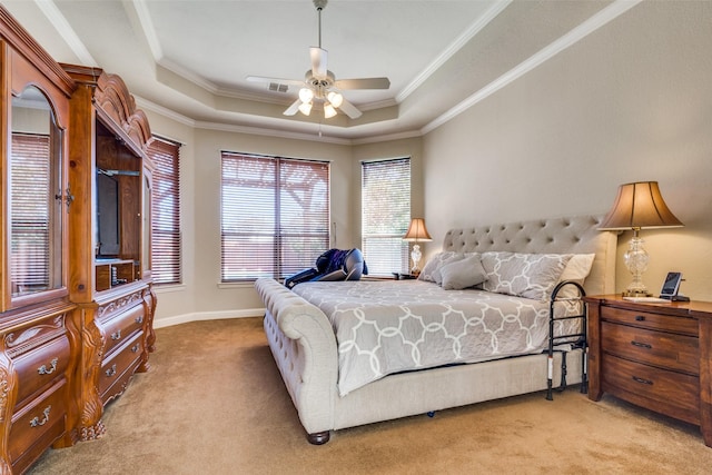 bedroom featuring a raised ceiling, ceiling fan, crown molding, and light carpet