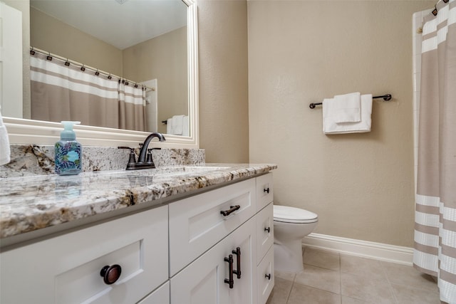 bathroom with tile patterned flooring, vanity, and toilet