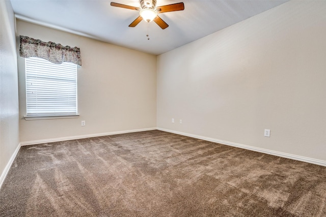 empty room featuring dark colored carpet and ceiling fan