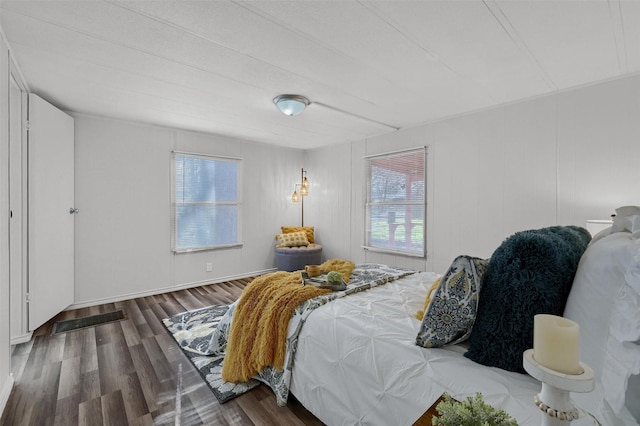 bedroom with dark hardwood / wood-style flooring