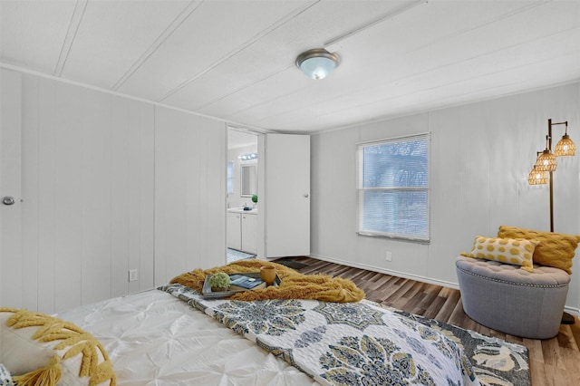 bedroom featuring hardwood / wood-style floors and connected bathroom