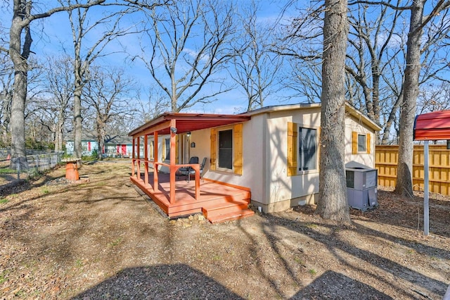 exterior space featuring covered porch, central air condition unit, and a wooden deck