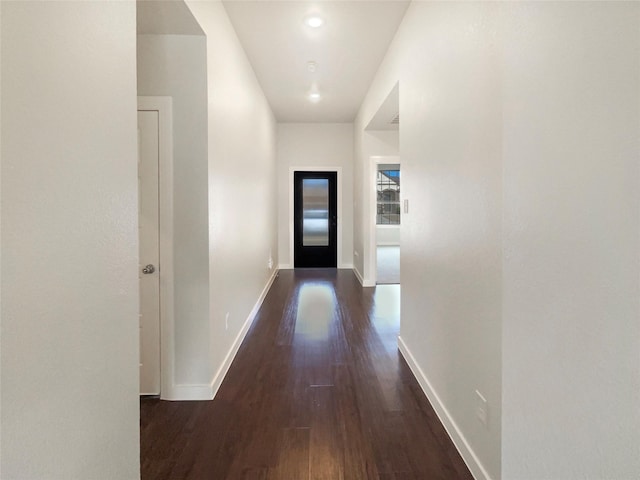 hallway with dark hardwood / wood-style flooring