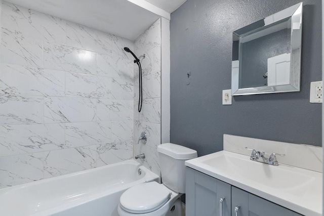 full bathroom featuring tiled shower / bath, vanity, and toilet