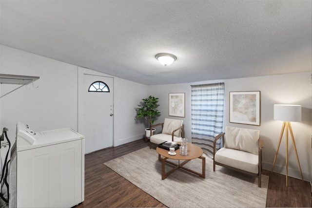 sitting room with washer / dryer, dark wood-type flooring, a textured ceiling, and plenty of natural light