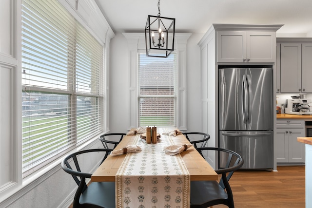 dining room with a notable chandelier and light hardwood / wood-style floors