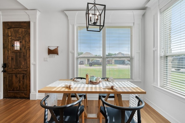 dining space with a chandelier and hardwood / wood-style floors