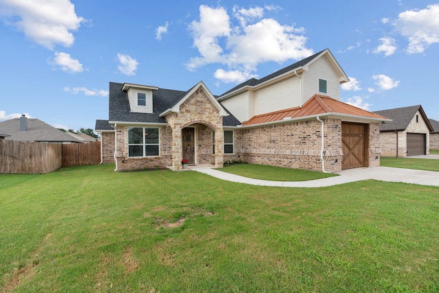 view of front of house with a garage and a front lawn