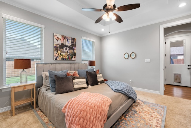 bedroom featuring ceiling fan, crown molding, and light carpet